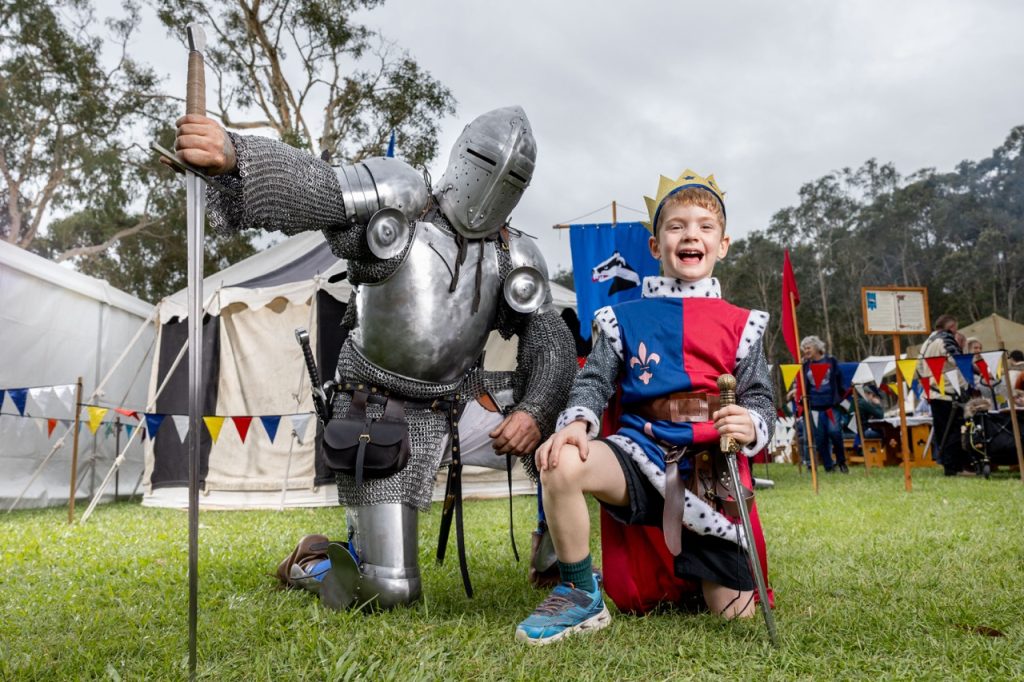 Child enjoying the Abbey Medieval Festival with a knight in Moreton Bay
