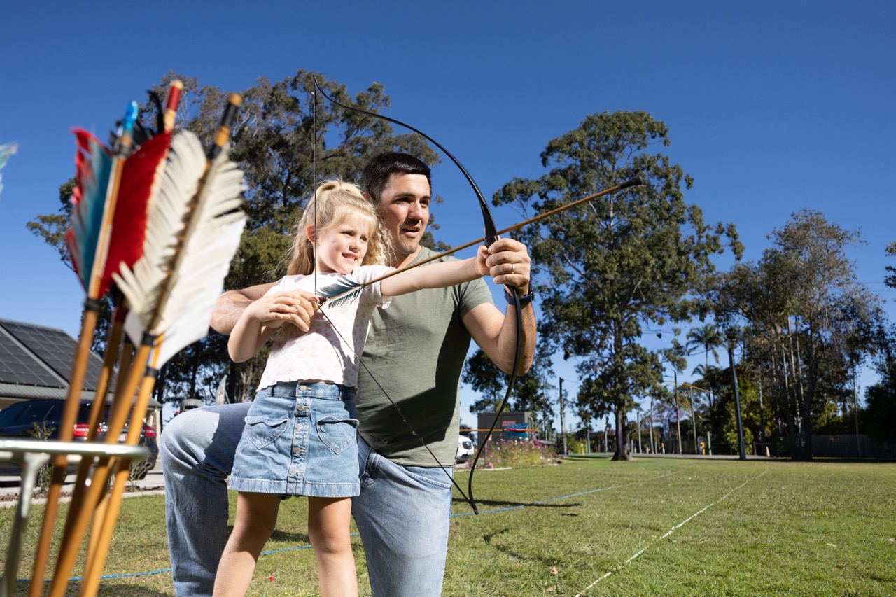 Child learning archery at the Abbey Museum during the Moreton Bay school holidays